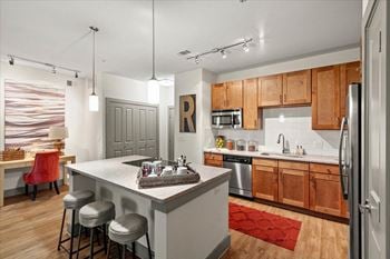 Modern kitchen with black stove top and wooden cabinets